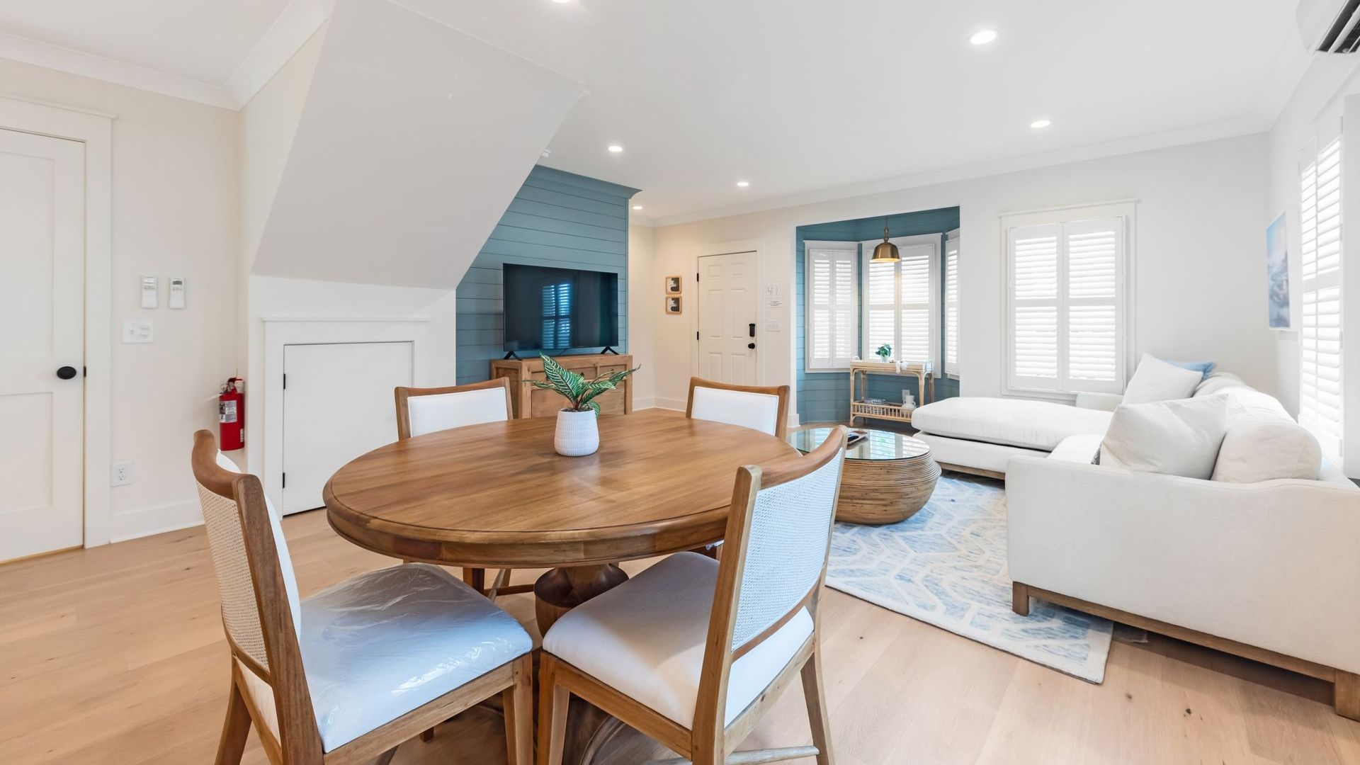 A living room with a round table and chairs and a couch.