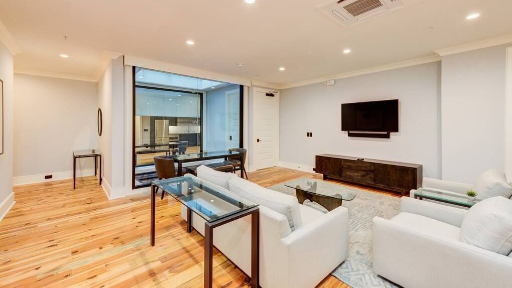 A living room filled with furniture and a flat screen tv.