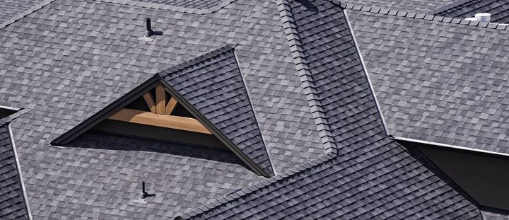 A close up of a roof with a window in the middle of it.