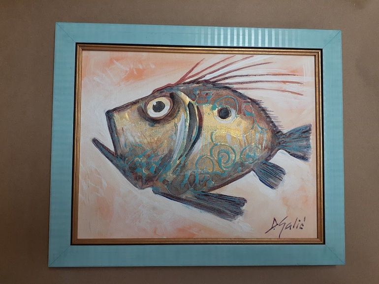 Abstract painting of a fish in blue, gold, and brown, framed in light blue with a gold inner border.
