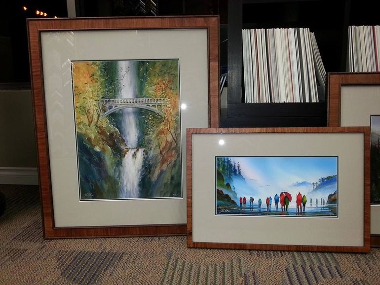 Watercolor paintings of waterfalls and a bridge, in ornate brown frames.