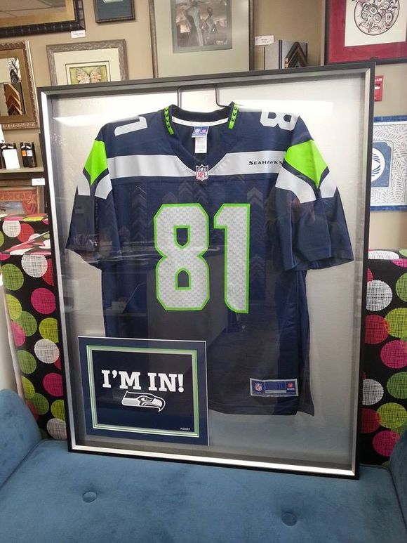 Framed Seattle Seahawks jersey with the number 81, displayed with 