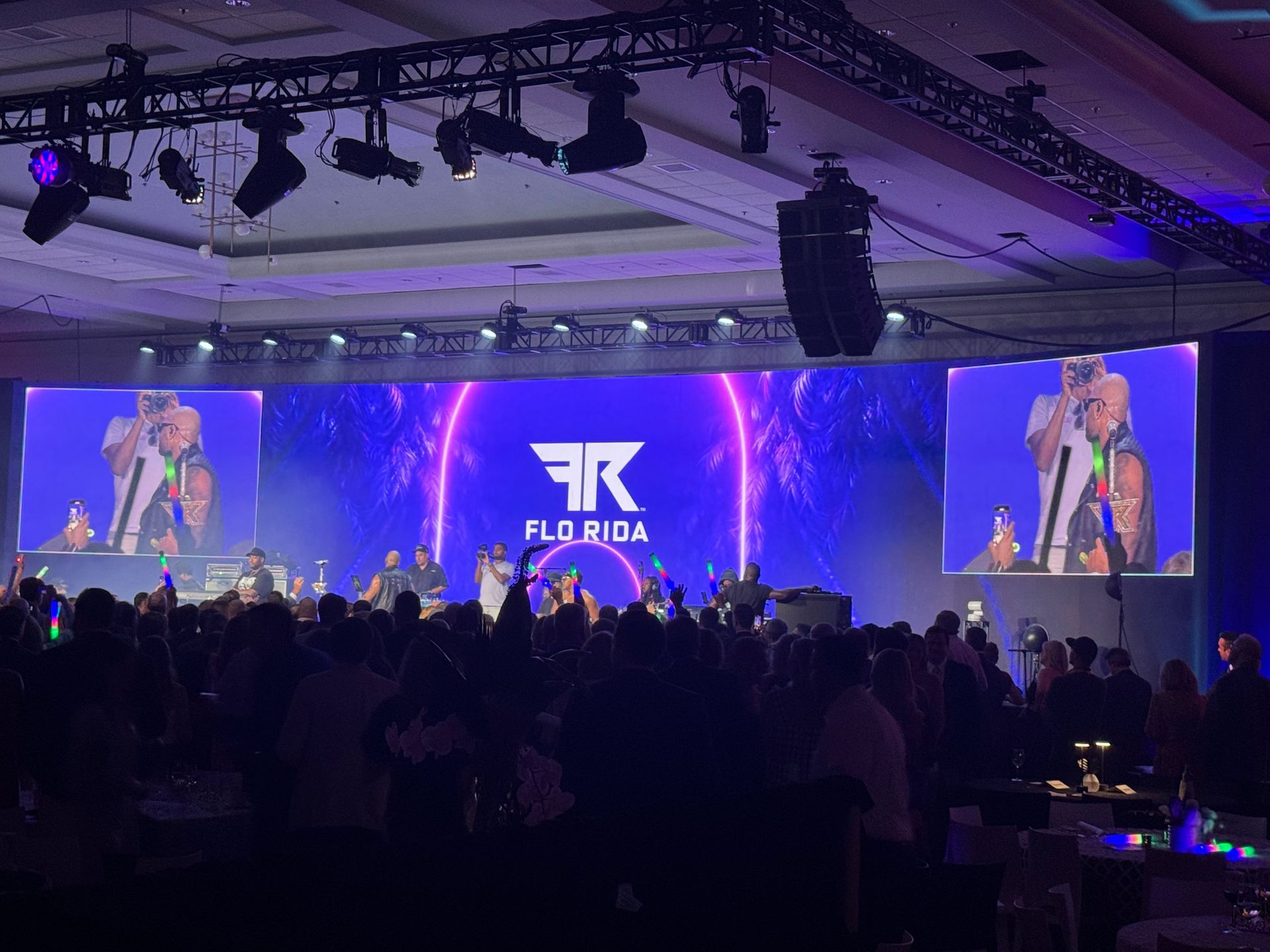 A concert stage with a large screen displaying 