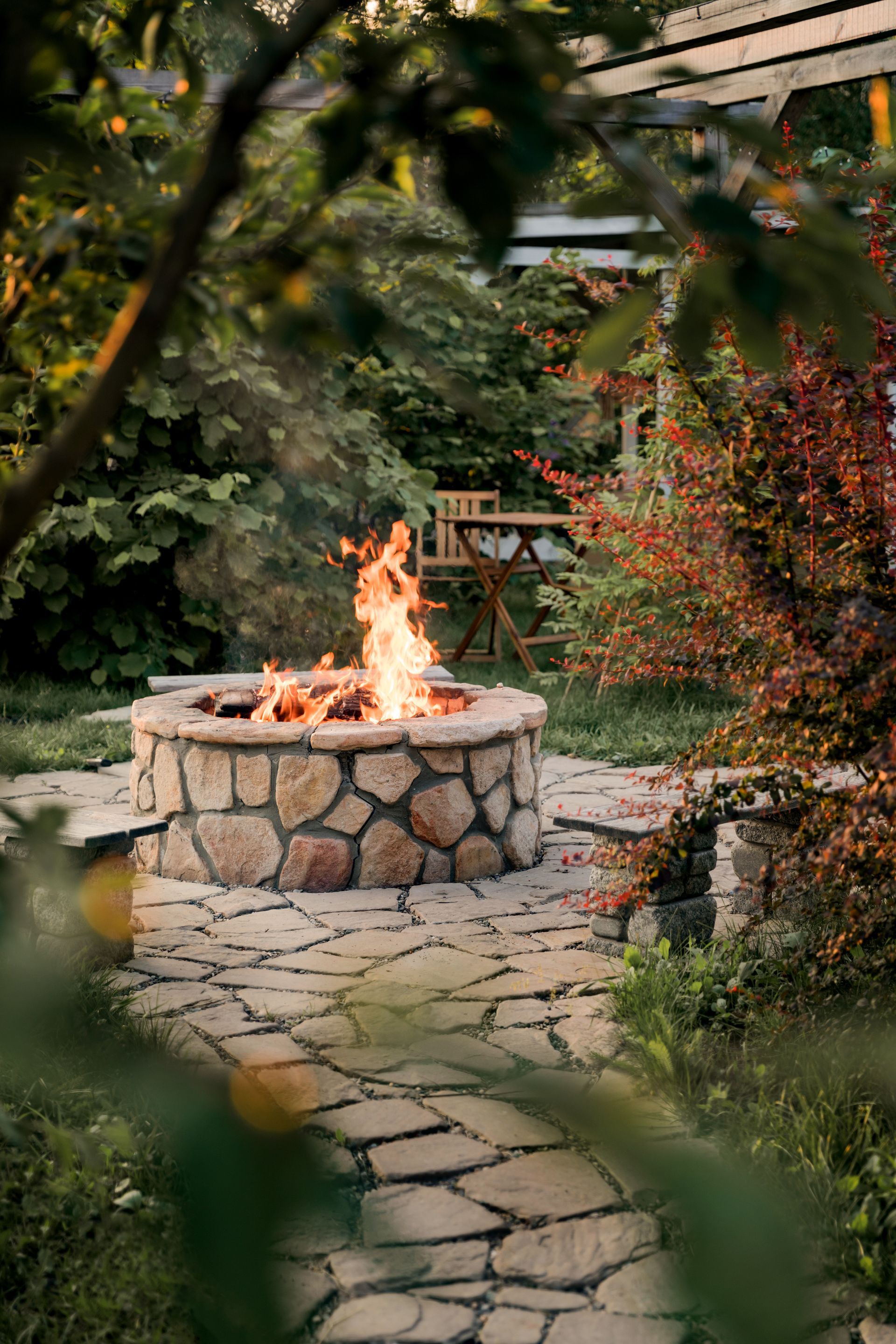 There is a fire pit in the middle of the garden.