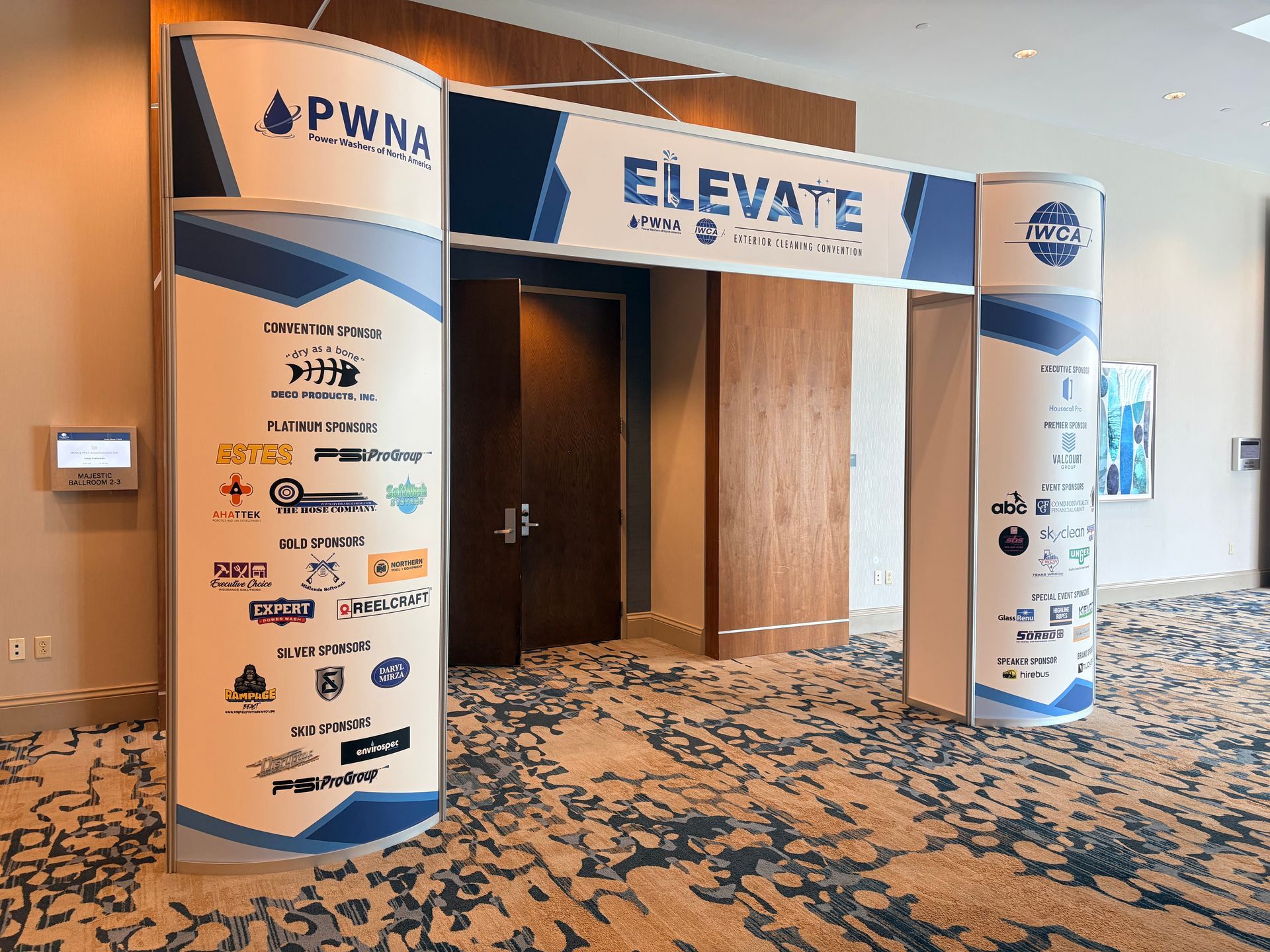 PWN logo archway and ELEVATE banner at a conference hallway entrance
