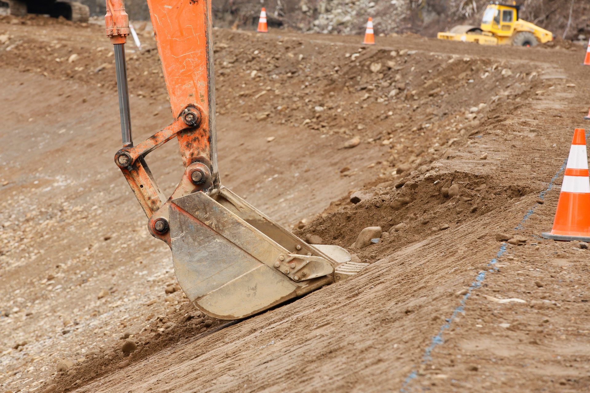 A bulldozer is digging a hole in the dirt on a construction site.