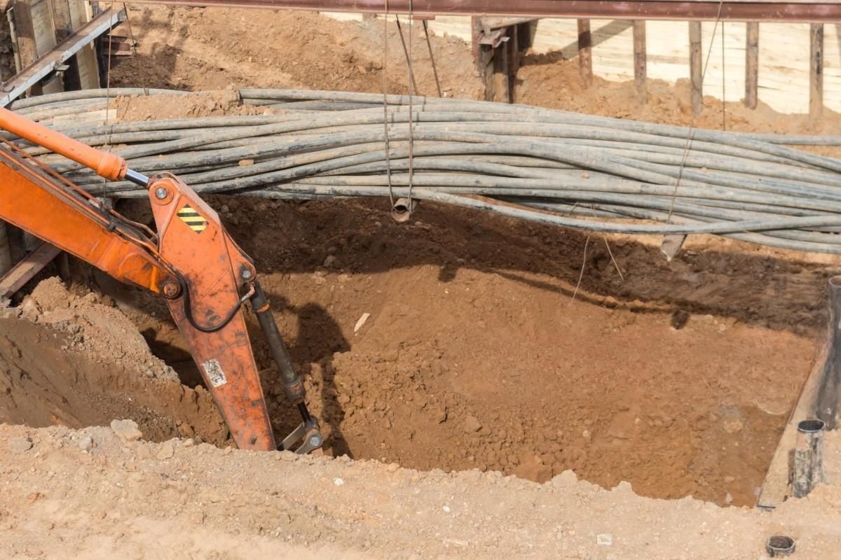 A construction vehicle is digging a hole in the ground.