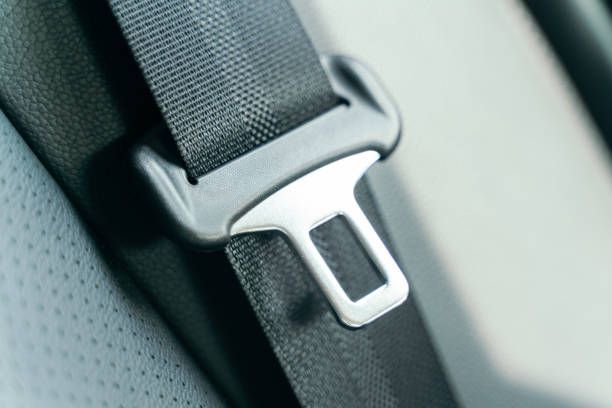 A close up of a seat belt on a car seat.