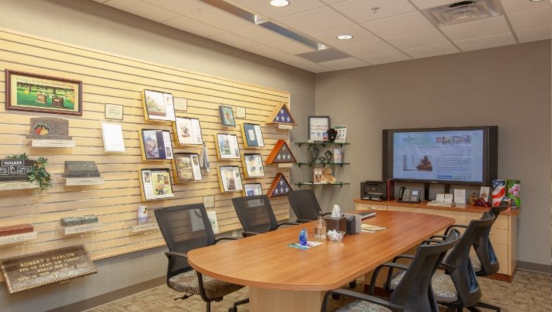 A conference room with a long wooden table and chairs.