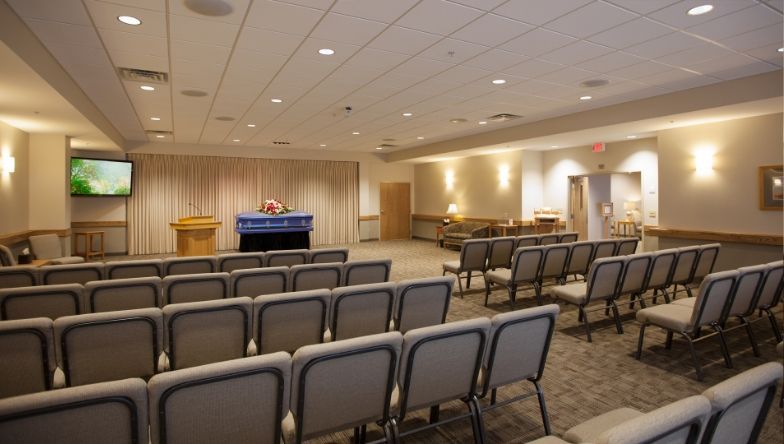 A large room with rows of chairs and a podium.