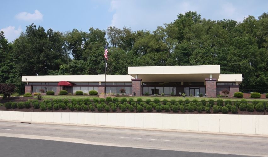 a large brick building with a parking lot in front of it