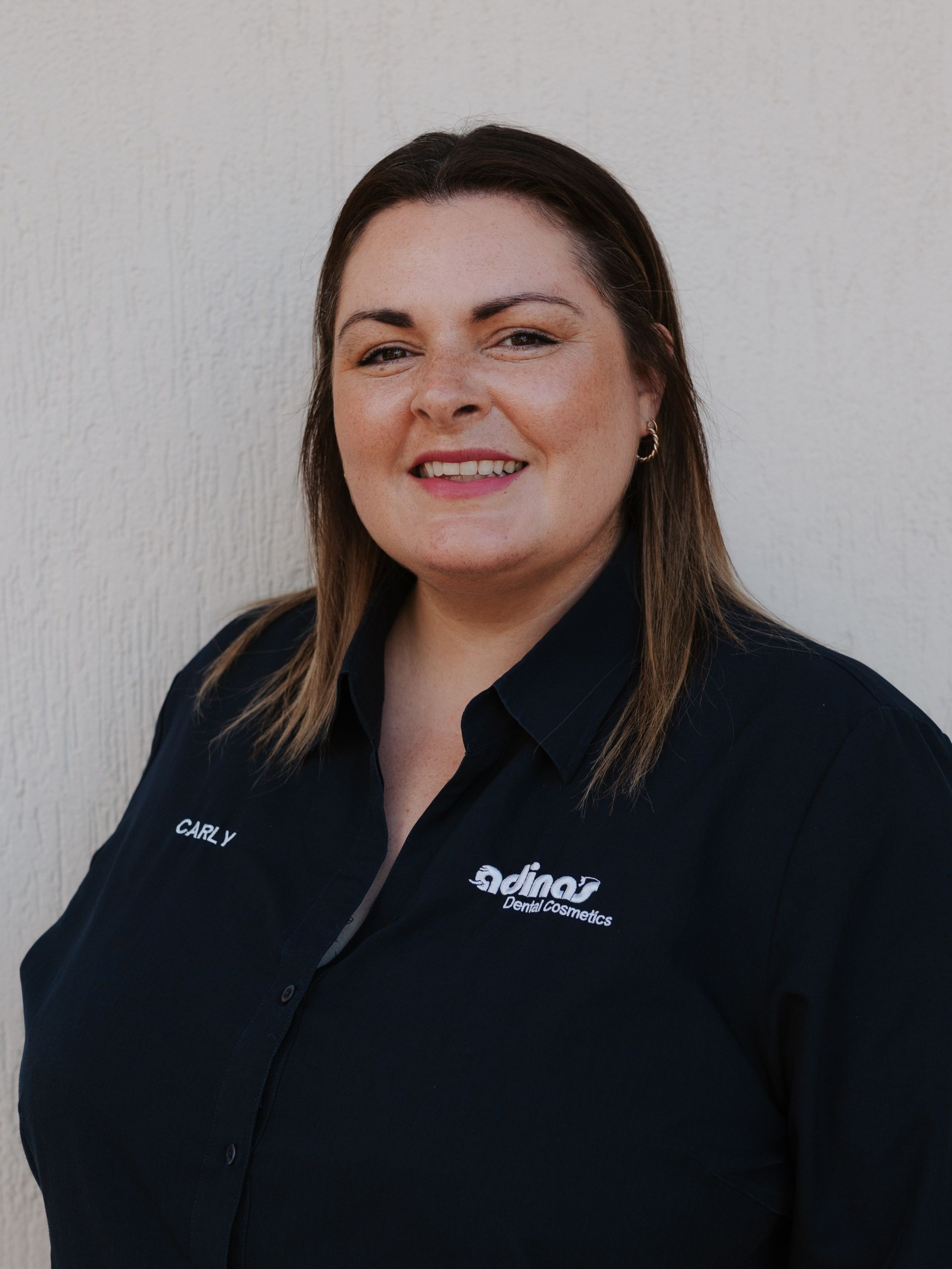 A group of people are posing for a picture in front of a building.