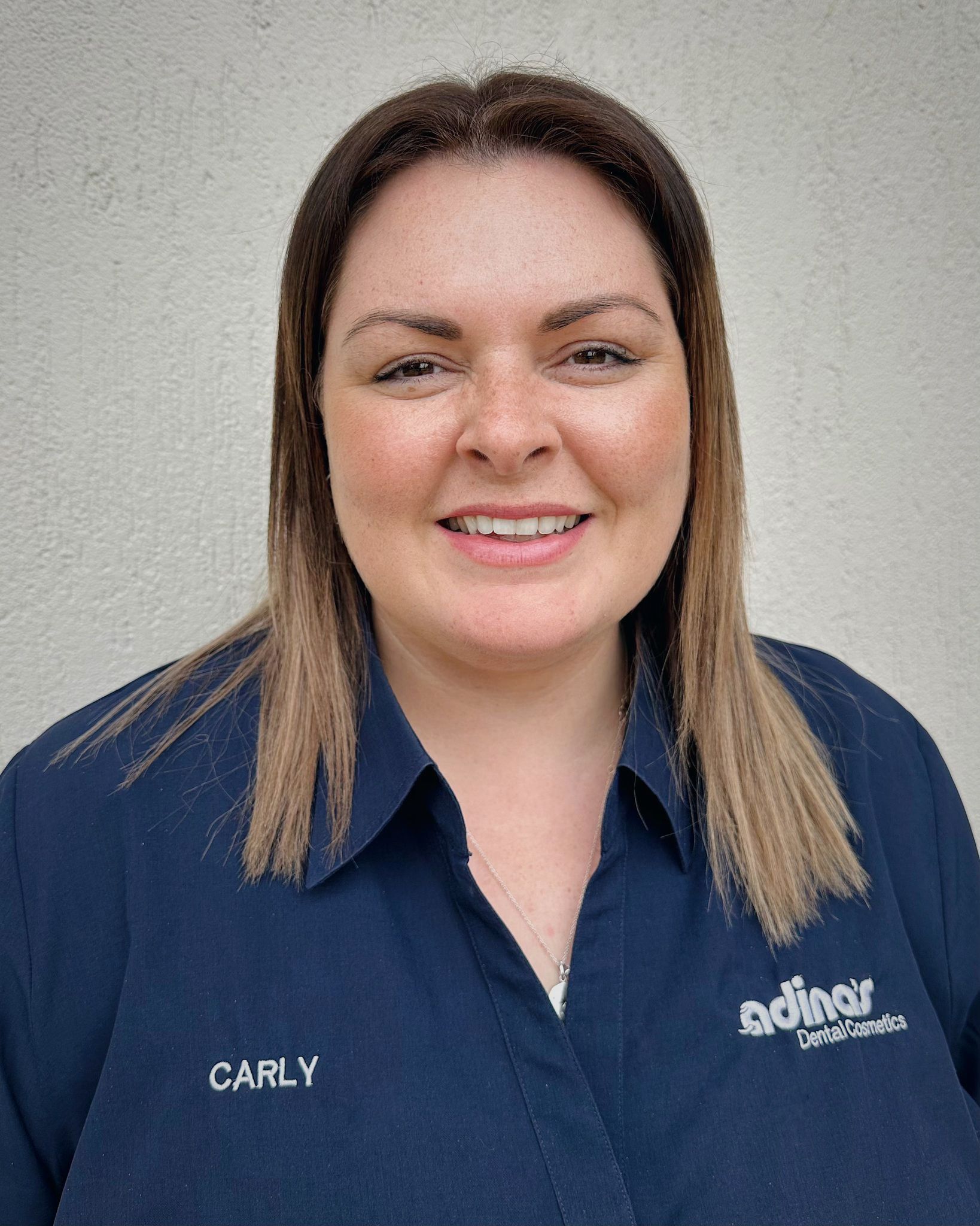 A group of people are posing for a picture in front of a building.