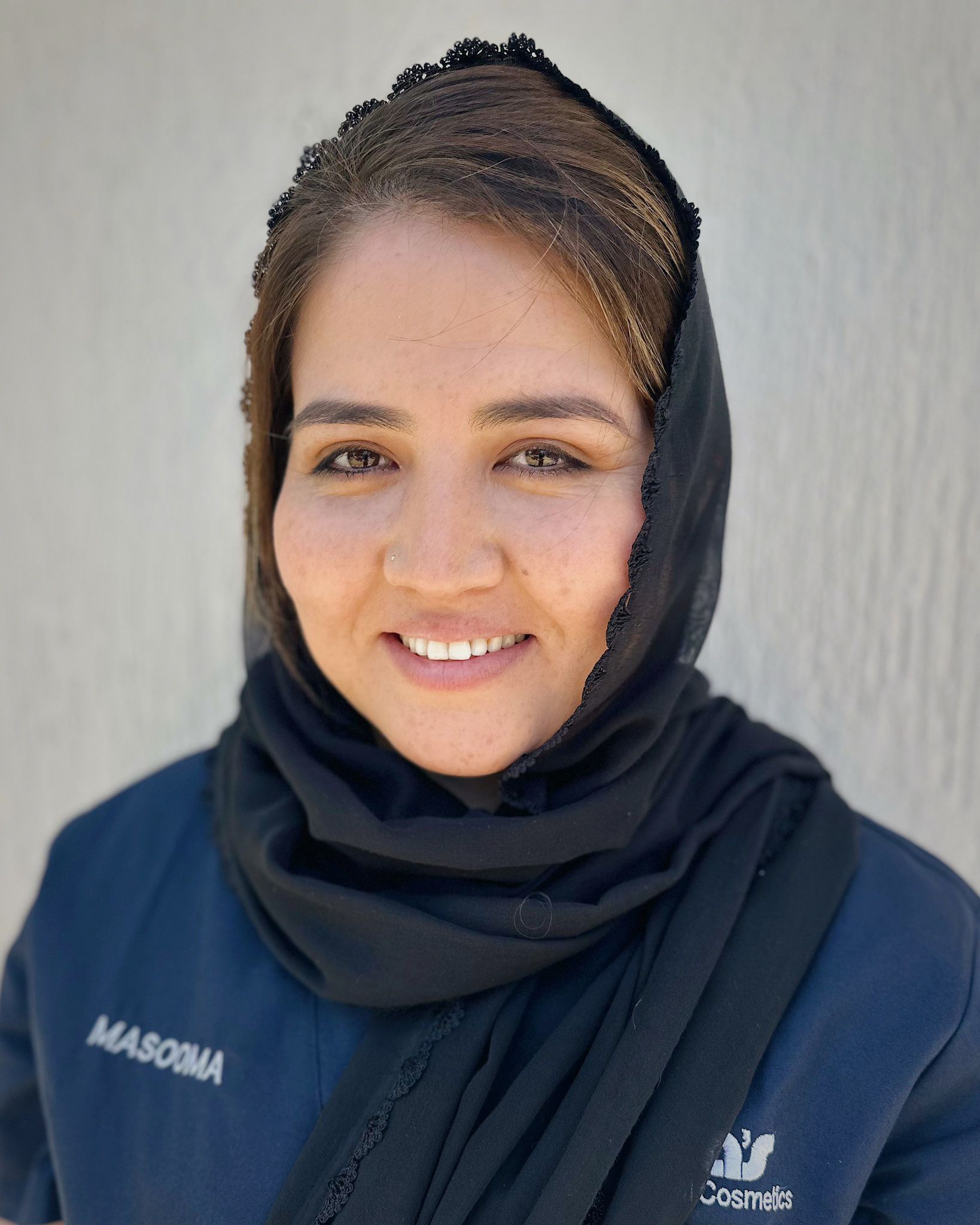 A group of people are posing for a picture in front of a building.