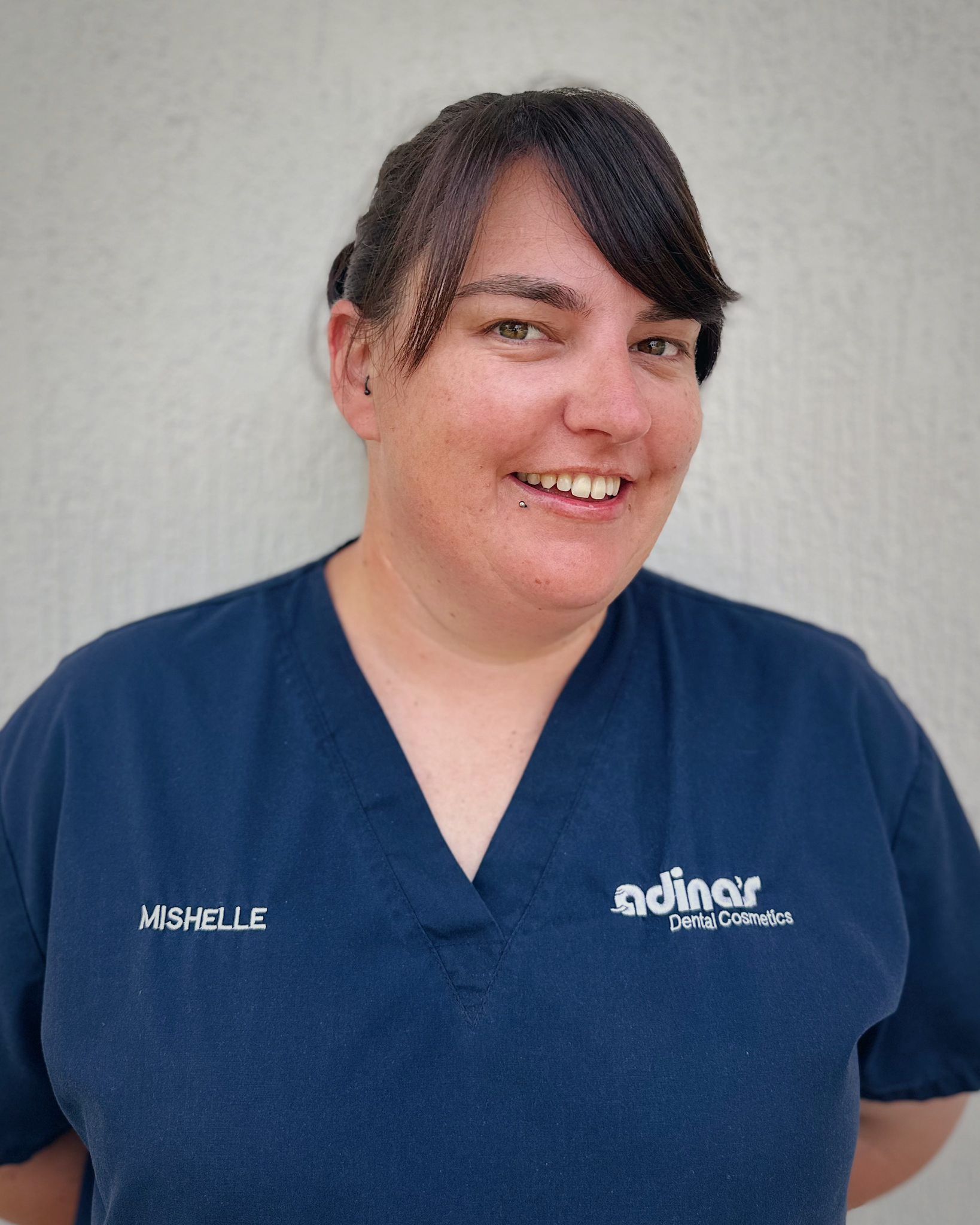 A group of people are posing for a picture in front of a building.