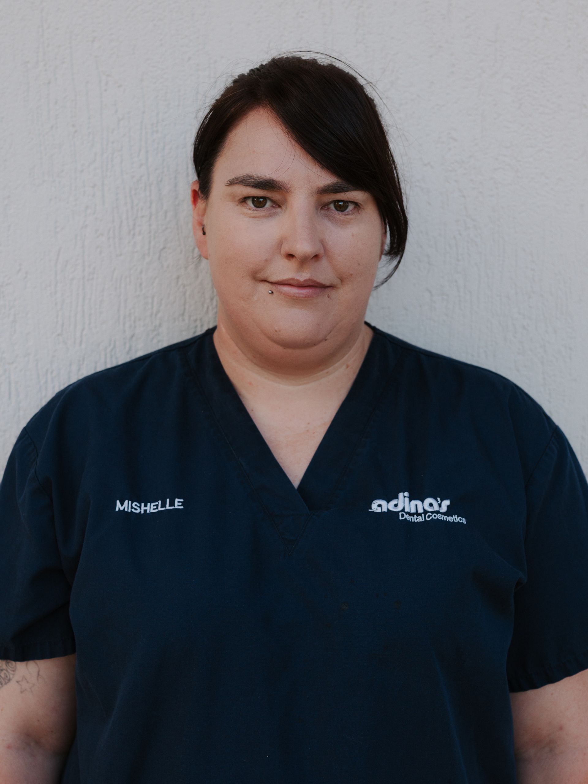 A group of people are posing for a picture in front of a building.