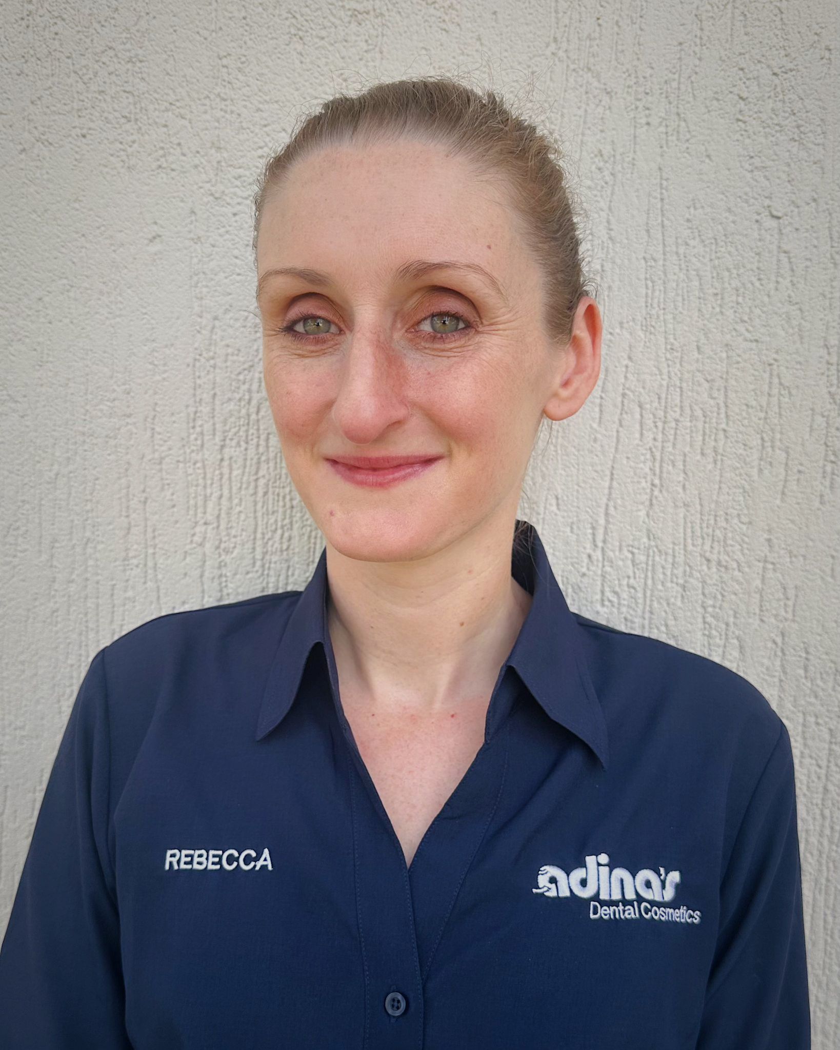 A group of people are posing for a picture in front of a building.