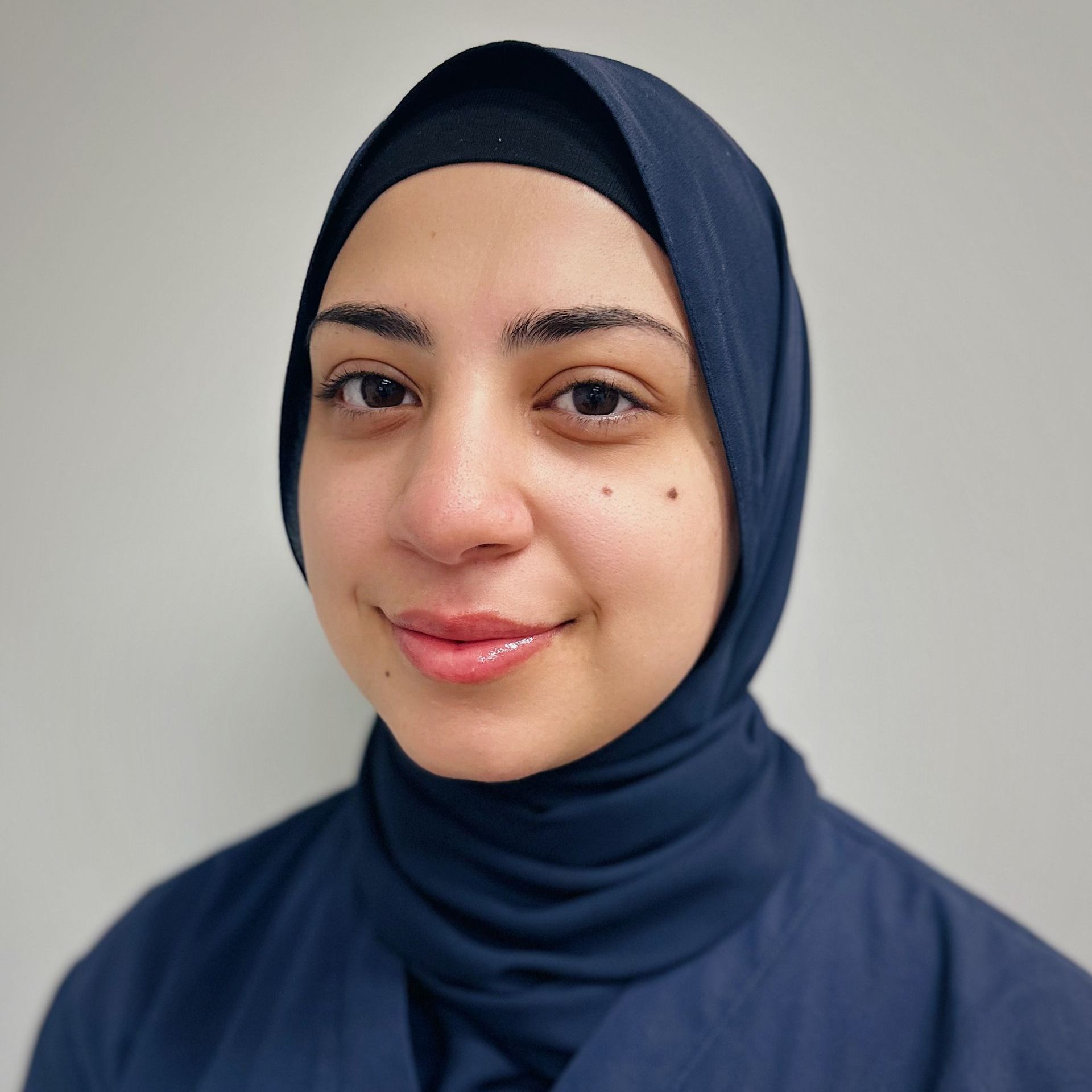 A group of people are posing for a picture in front of a building.
