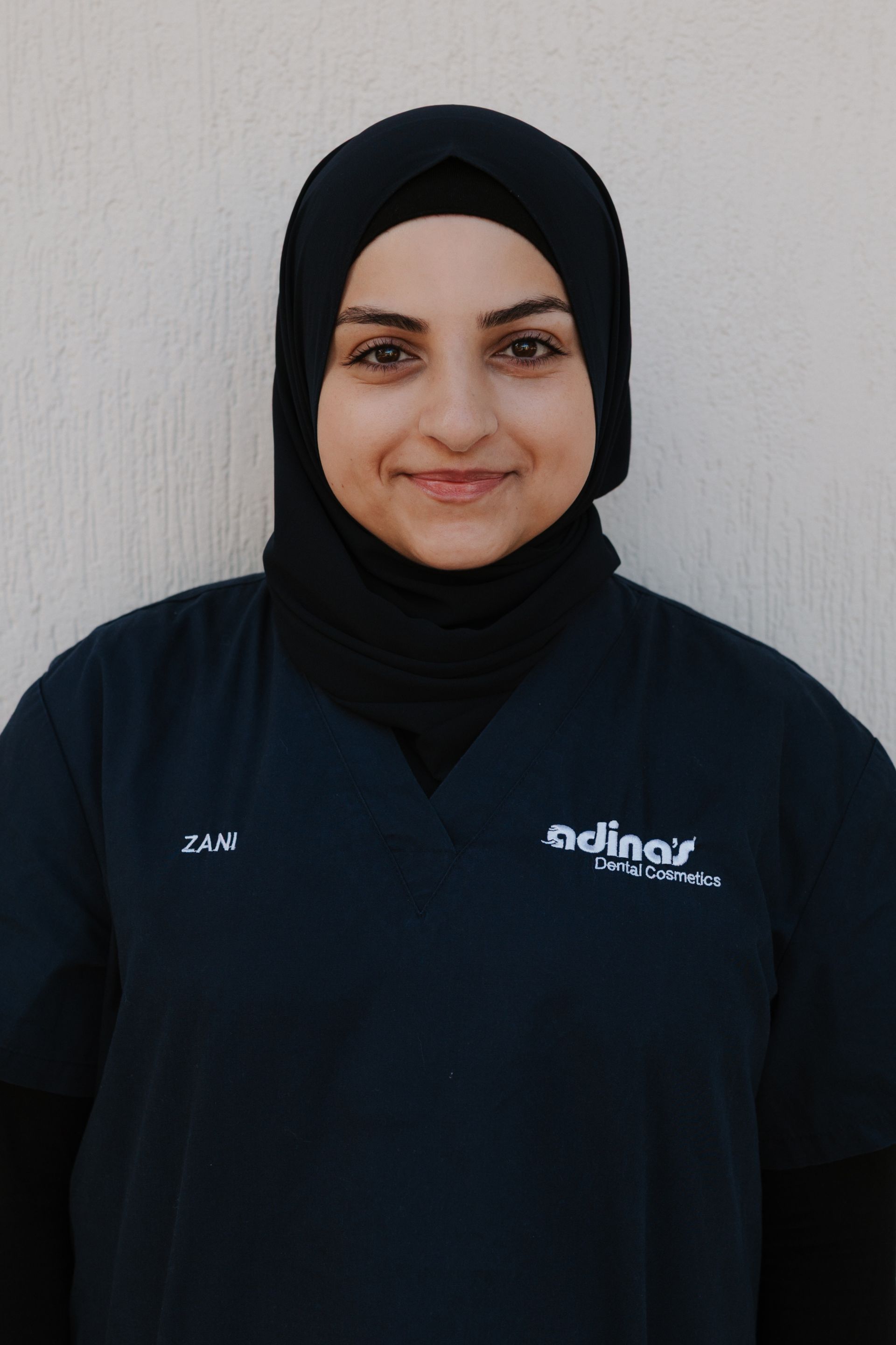 A group of people are posing for a picture in front of a building.