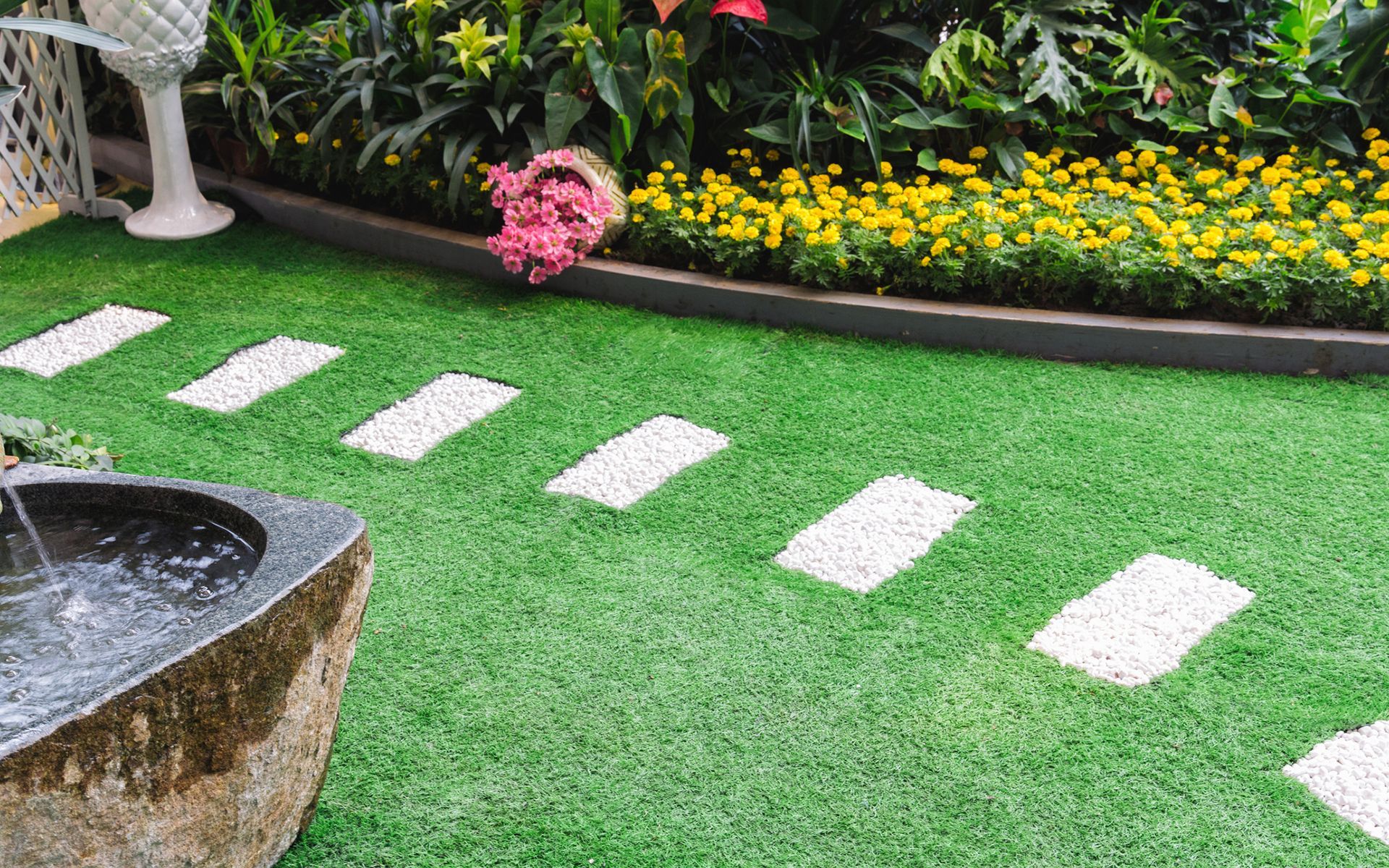 There is a fountain in the middle of the garden.