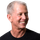 A man wearing a black shirt is smiling for the camera