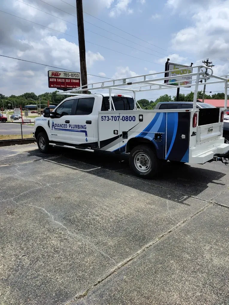 Two people doing yoga outside. One in pink, one in white, arms outstretched, smiling.