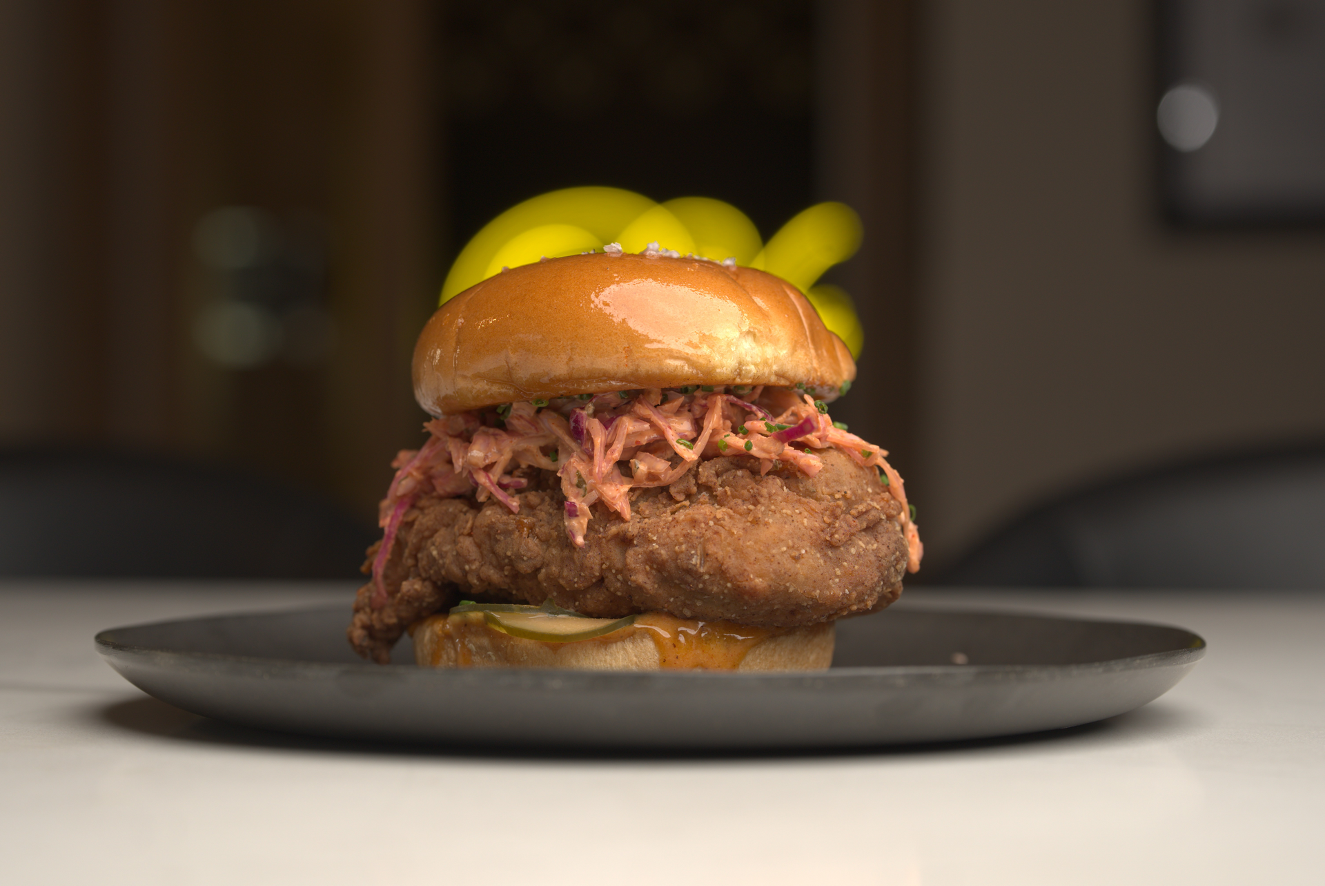A close up of a chicken sandwich on a plate