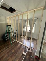 a room with a wooden wall and a ladder in it .