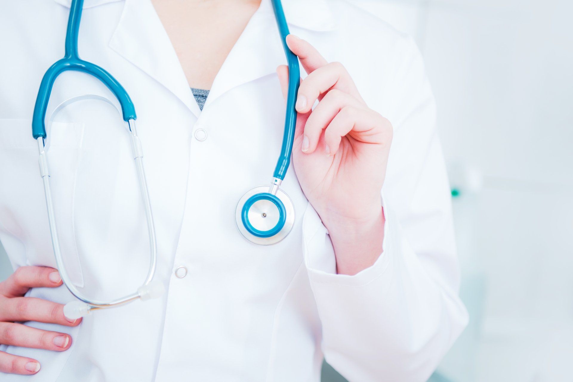 A doctor is holding a stethoscope around her neck.