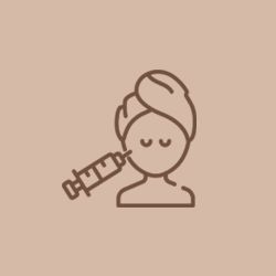 a woman with a towel wrapped around her head is getting a botox injection .