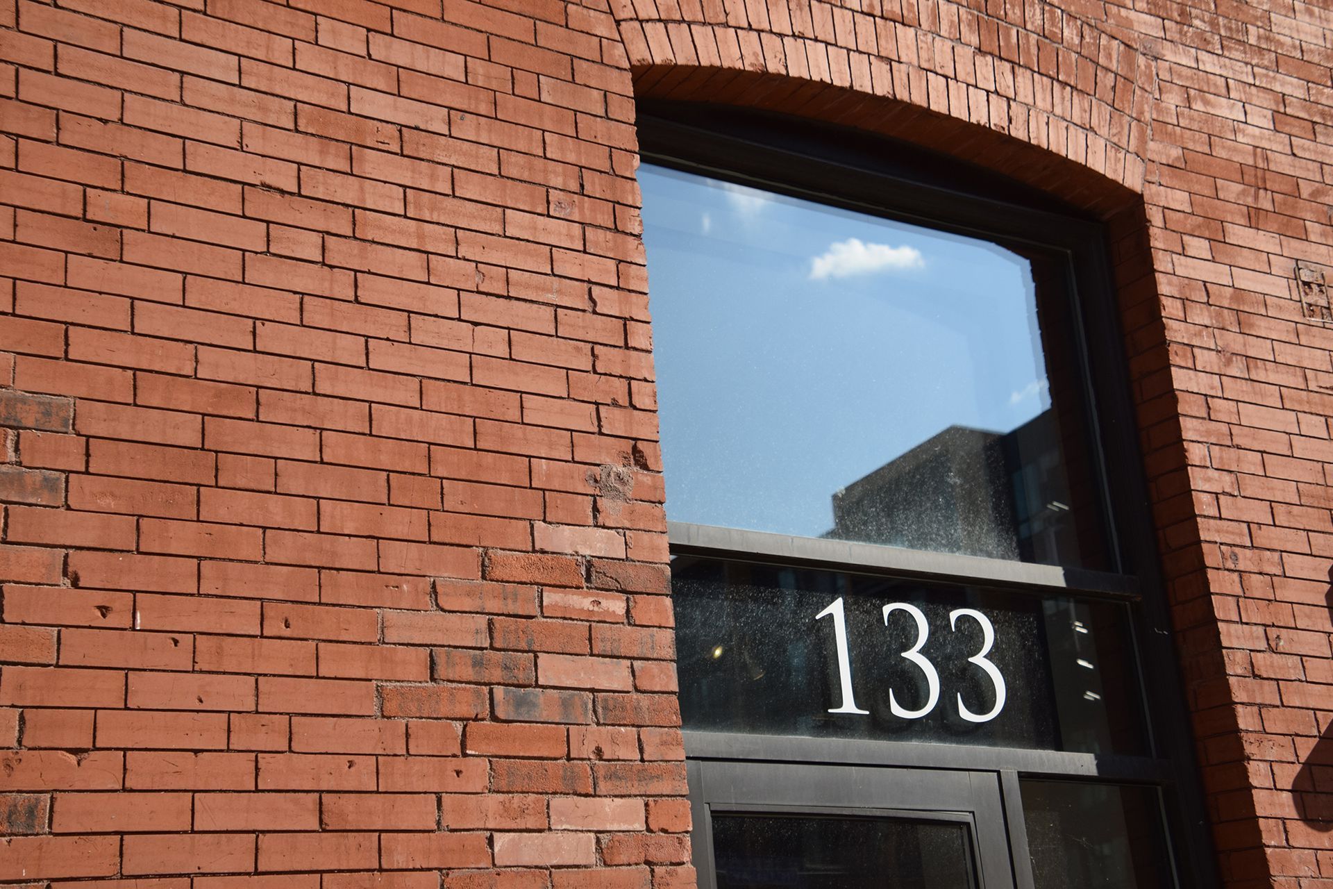 Brick building with arched window; 