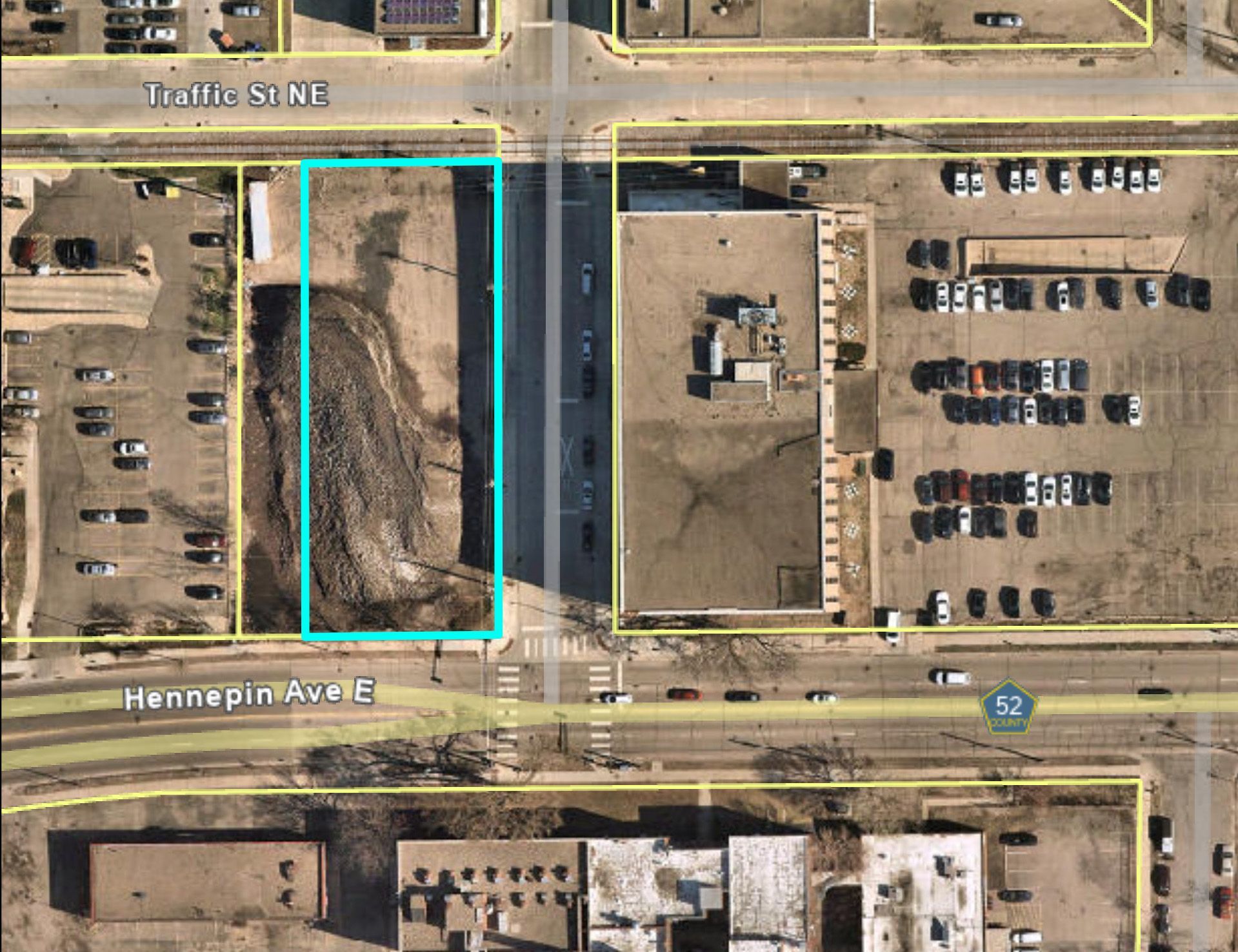 Aerial view of property with parcels outlined in blue between buildings and roads. Hennepin Ave and Taft St NE.