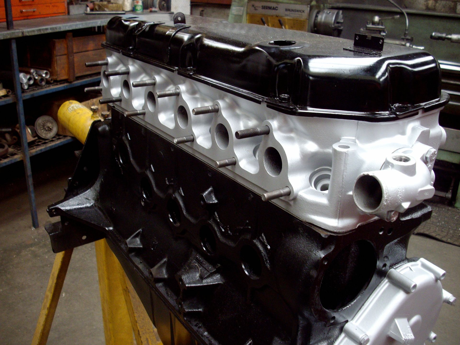 A black and white engine is sitting on a wooden table