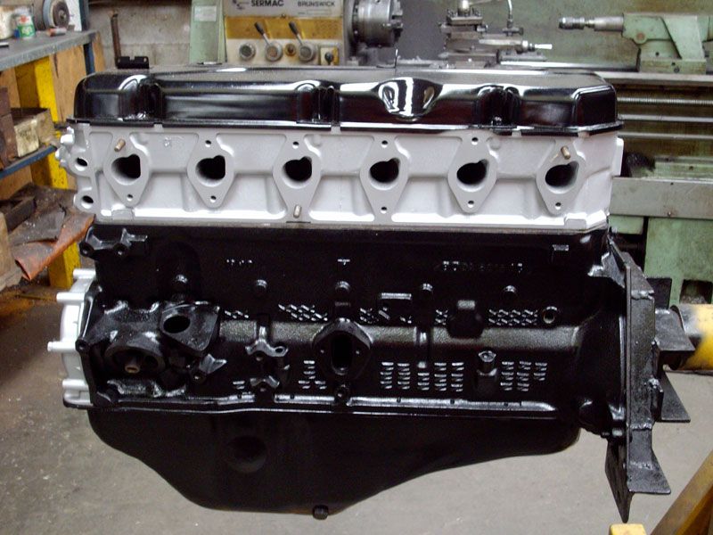 A black and white engine sits in front of a machine