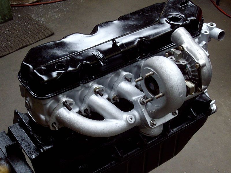 A black engine with a turbo on top of it