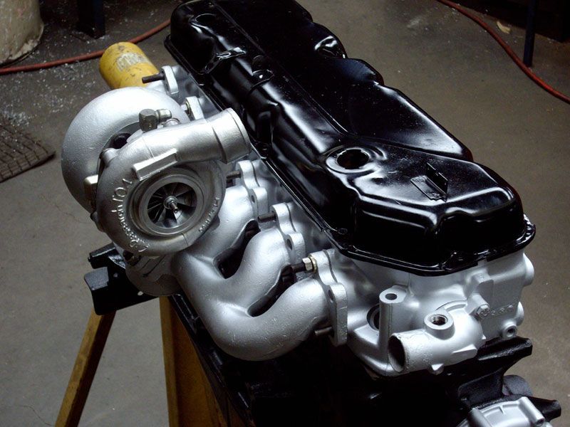 A car engine with a turbo on top of it