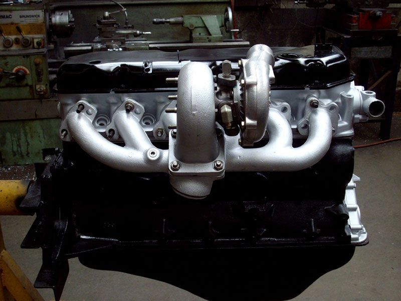 A black engine with a turbo on top of it