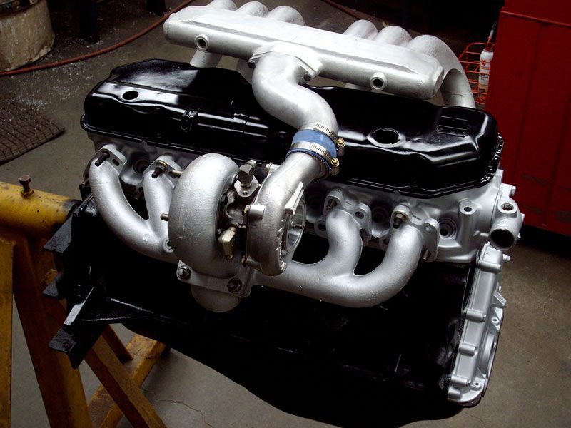 A black and silver engine with a turbo on it
