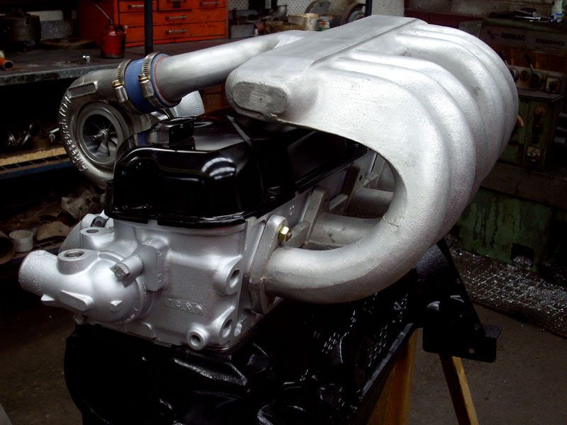 A black and silver engine with a turbo attached to it
