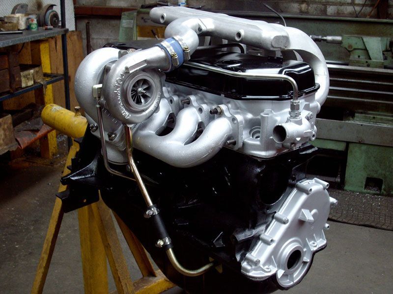 A black and silver engine with a turbo on it