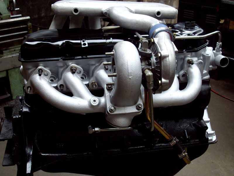 A close up of a car engine with a turbo