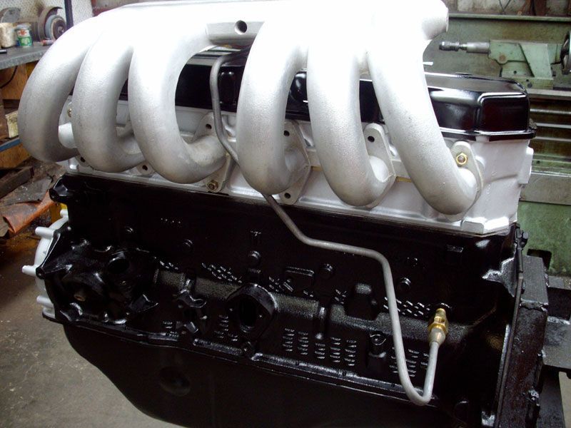 A black engine with white pipes attached to it