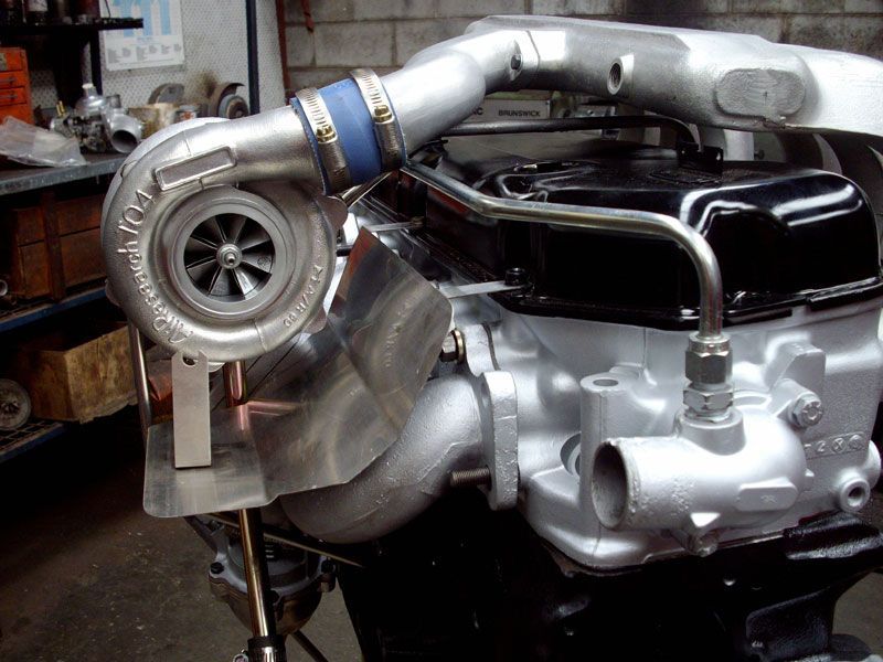 A turbocharger is attached to a car engine