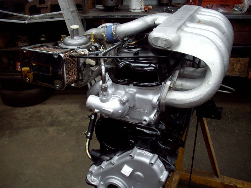 A black and silver engine is sitting on a wooden table