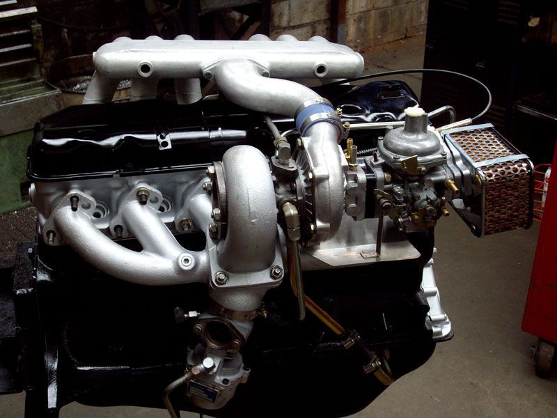 A car engine with a turbo attached to it