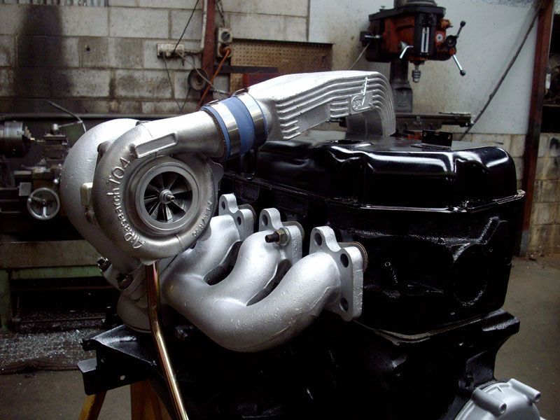 A black engine with a turbo on top of it