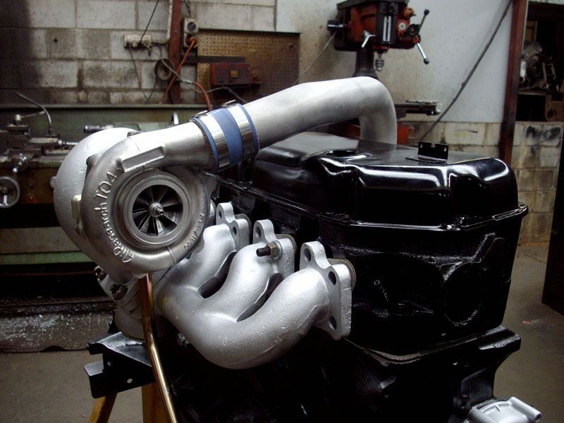 A turbocharger is attached to a black engine