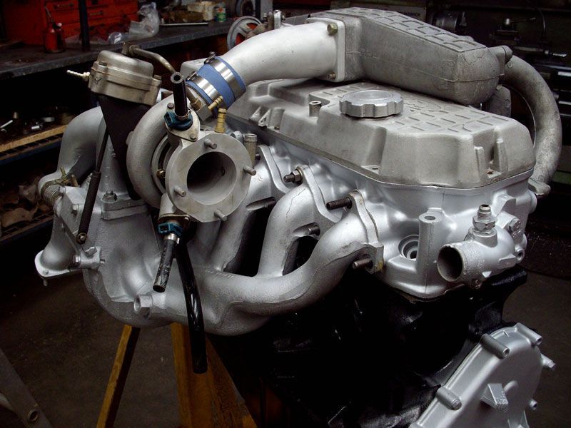 A close up of a car engine with a turbo