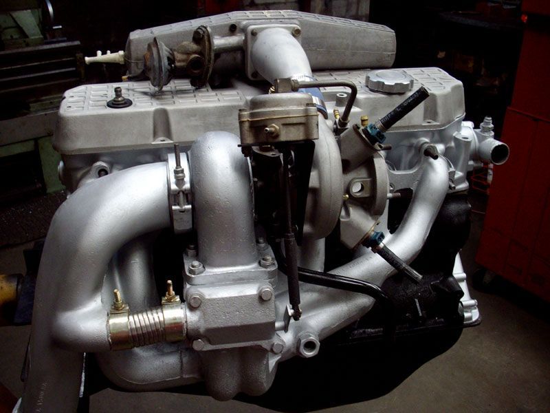 A close up of a car engine with a turbo