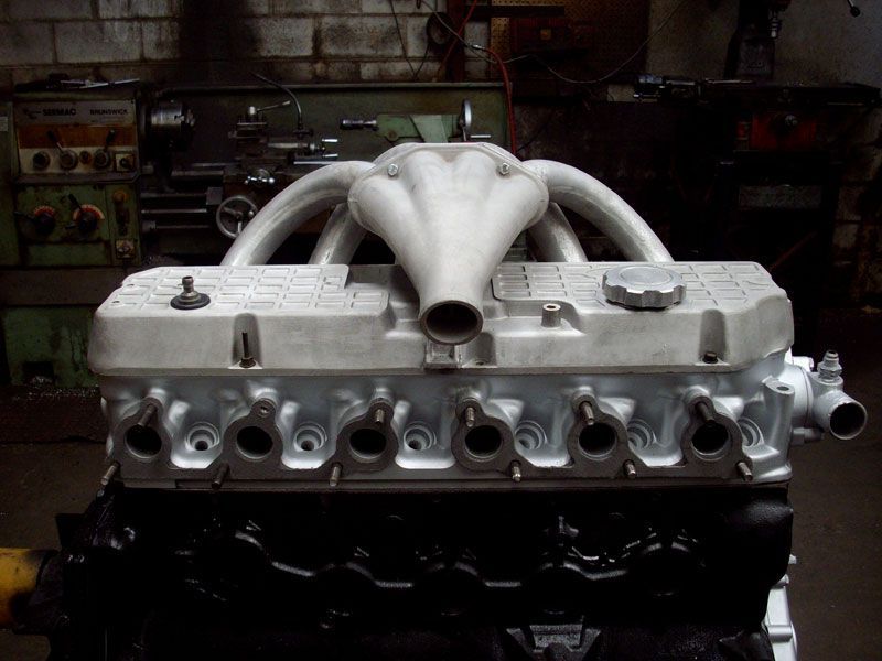 A close up of a car engine in a garage